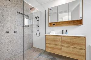 a bathroom with a shower and a sink at Sheoak in Paynesville +6 photos