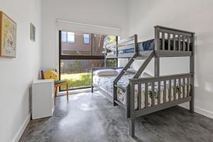 a bedroom with two bunk beds and a window at Sheoak in Paynesville