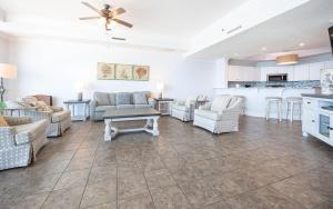 a large living room with couches and a kitchen at Phoenix West 603 in Orange Beach