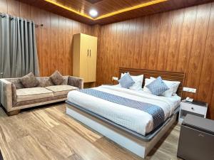 a bedroom with a bed and a couch at HOTEL N K RESIDENCY in Guwahati