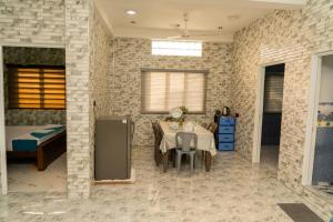 a room with a table and a bed and a bedroom at Risha villa in Trincomalee