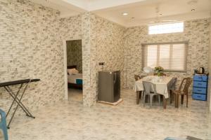 a dining room with a table in a brick wall at Risha villa in Trincomalee