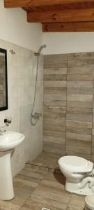 a bathroom with a toilet and a sink at Relax apart in Trelew