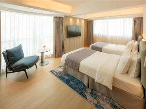 a hotel room with a bed and a chair at Inn Hotel Macau in Macau +26 photos