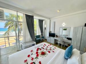 a bedroom with a bed with flowers on it at Baia Dikwella in Batigama +63 photos