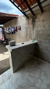 a bathroom with a sink in a stone wall at Parnaíba cantinho do sossego in Parnaíba +18 photos