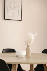 a wooden table with a vase on top of it at Unit 2, Rocky CBD in Rockhampton