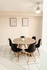 a dining room with a wooden table and chairs at Unit 2, Rocky CBD in Rockhampton