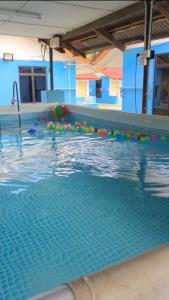 a swimming pool with colorful balls in the water at Mutiara Chalet in Malacca