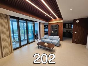 a living room with a couch and a table at Miracle Suite House 1 in Incheon +32 photos