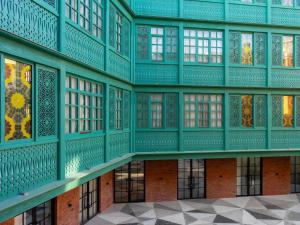 an empty building with green walls and windows at ibis Styles Old Tbilisi in Tbilisi City