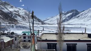 a view of a snow covered mountain with a building at Dungkhar homestay in Kaza