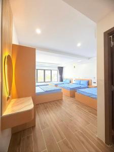 a bedroom with three beds and a balcony at Phương Ngân HOTEL in Hà Tiên +21 photos