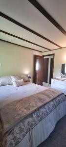 a bedroom with a large bed in a room at Waypoint Lodge in Naseby +4 photos