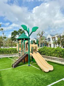 a playground with a slide and a tree at ACIS SmartHome NovaWorld in Bình Tú