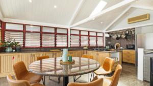 a kitchen with a table and chairs in a room at Sea Light in Currarong