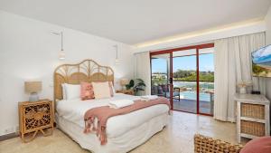a bedroom with a large bed and a balcony at Sea Light in Currarong +30 photos