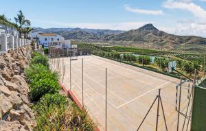 a tennis court with mountains in the background at La Casa Grande in Málaga