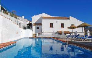 a swimming pool in front of a white house at La Casa Grande in Málaga +14 photos