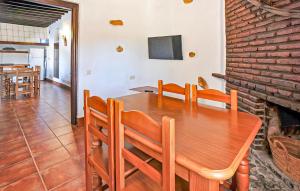 a dining room with a wooden table and a fireplace at La Casa Grande in Málaga