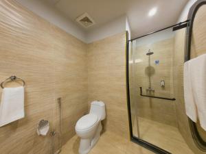 a bathroom with a toilet and a shower at Hotel One Gujranwala in Kot Mergulla +40 photos