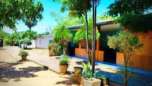 a house with palm trees in front of it at Nilaveli Better Beach Resort in Nilaveli