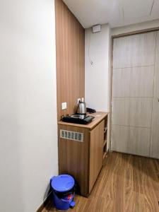 a small kitchen with a tea kettle on a counter at Comfort Corner in Greater Noida +7 photos