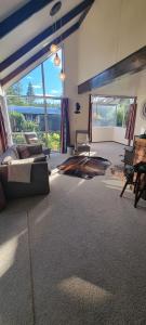 a living room with a bed and a large window at Waypoint Lodge in Naseby