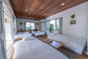 Llit o llits en una habitació de ブーゲンビリア