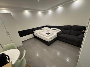 a small room with a bed and a couch at Studio Apartment next to Airport in Kelsterbach +4 photos
