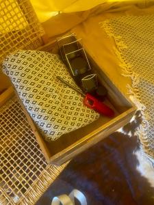 a pair of scissors sitting on a piece of yellow net at Kiowa Teepee at Nomad Landing in Clayton