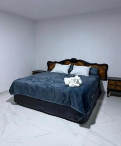 a bed with a stuffed animal on top of it at Casa Azteca de Oro in San Sebastian Xolalpa
