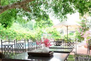 a glass table with a vase on top of it at Tigon Villa in Mỹ Ðuc +10 photos