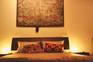 a bedroom with a bed with two lamps and a painting on the wall at Le Cœur Urban Suite Parma in Parma +29 photos