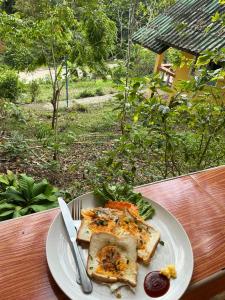 a plate of food on a wooden table at elephant garden in Ban Bang Bao