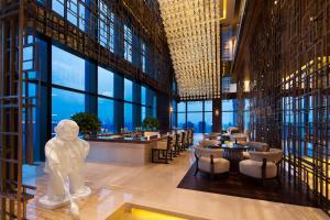 a restaurant with a statue in the middle of a building at Grand Hyatt Shenyang in Shenyang