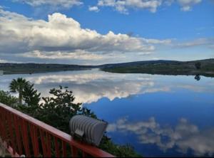 a bench sitting next to a body of water at RosePlace Valsequillo in Durazno