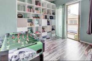 a room with a foosball table and shelves at La Lanterne Plage in Nice