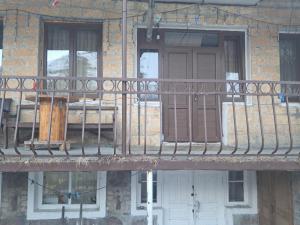 a balcony of a building with a door and windows at Hotel Kazbegi11 in Ach'khoti