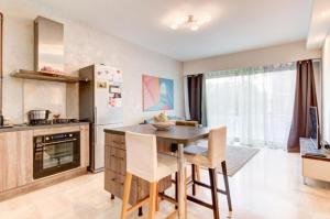 a kitchen with a table and chairs in a room at La Lanterne Plage in Nice