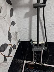 a pipe in a bathroom with a tile wall at Hotel Kazbegi11 in Ach'khoti