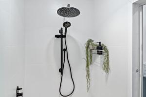 a bathroom with a shower on the wall at River Retreat in Dora Creek +12 photos