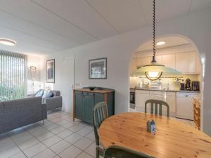 a living room with a table and a kitchen at Holiday Home near Dutch Beach with Pool in Sint Maartensvlotbrug +45 photos