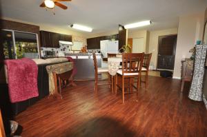 a kitchen and dining room with a table and chairs at Garden House in Courtenay