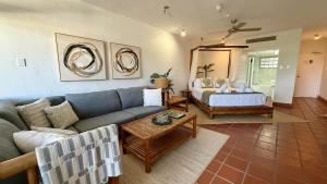 a living room with a couch and a bed at Bella Vista Coral Sea Views in Port Douglas