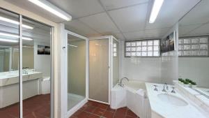 a large bathroom with two sinks and a shower at Bella Vista Coral Sea Views in Port Douglas