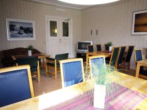jadalnia ze stołem, krzesłami i telewizorem w obiekcie Ediths Pensionat w mieście Karlsborg