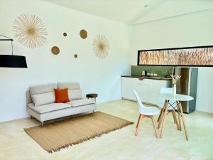 a living room with a couch and a table at Samma Villas - Onyx Villa - 1 BDR & Private Pool in Ko Phangan