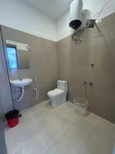 a bathroom with a toilet and a sink at Hotel unity Park in Pondicherry