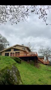 a house on a hill with a wooden bridge at Alta Peak Vista in Three Rivers